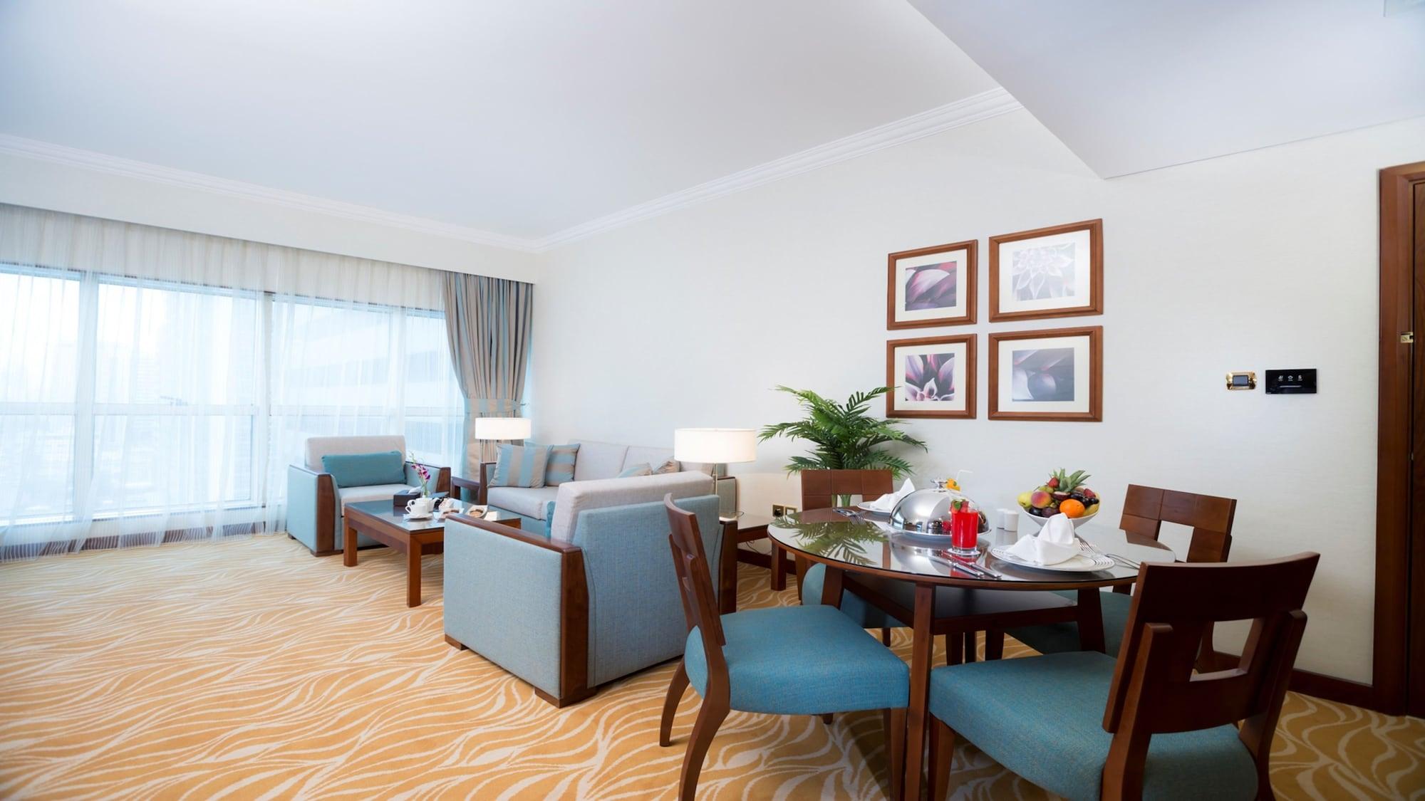 Grand Mercure Majlis Residences Abu Dhabi Exteriör bild A living room in a suite at the Jumeirah Beach Hotel