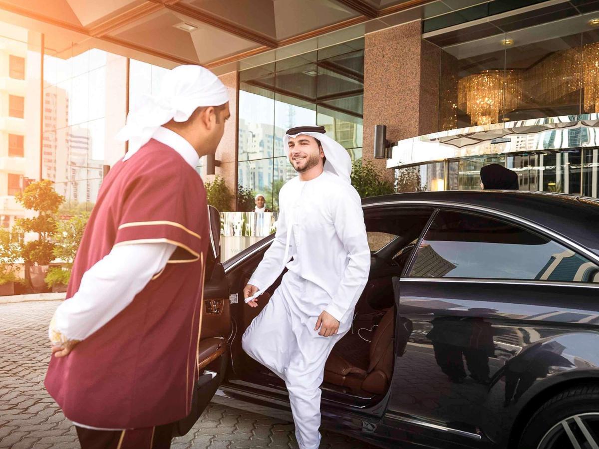 Grand Mercure Majlis Residences Abu Dhabi Exteriör bild A guest being helped out of a car